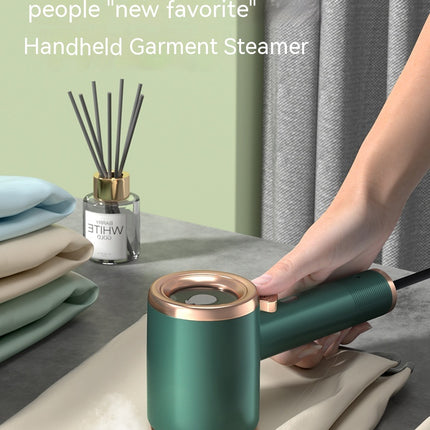 Mini handheld garment steamer – green on hanging clothes